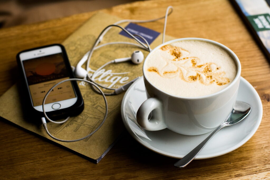 coffee and phone with earphones plugged