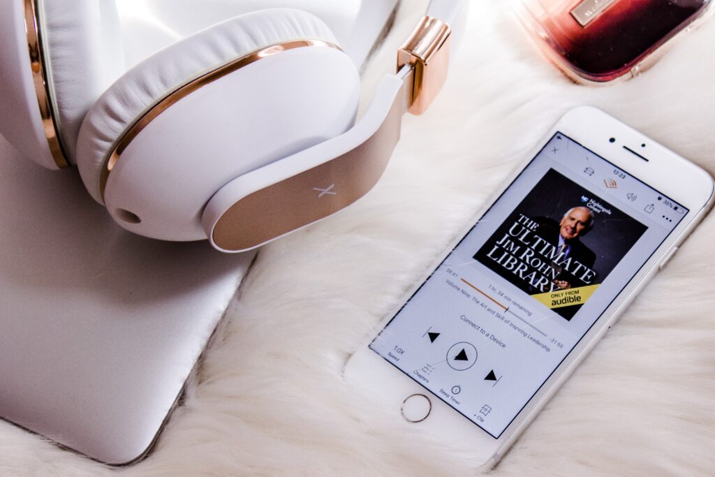 photo of headphones and a phone showing an audiobook, gift ideas for bookworms